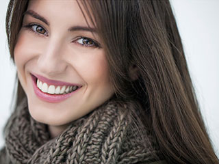 woman with scarf on smiling
