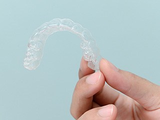 Patient holding clear aligner