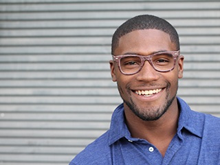 Patient in McComb smiling after dental crown restoration