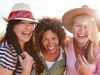 Patient in McComb smiling confidently with friends
