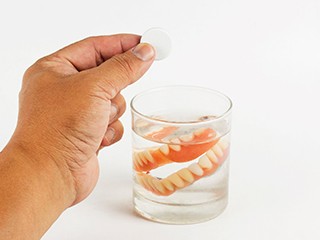 Dentures soaking in glass