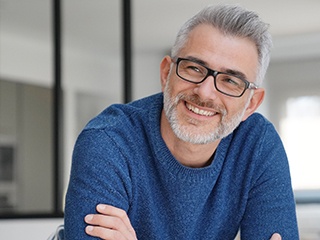 closeup of man smiling with arms crossed