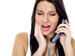Pained woman calling her McComb emergency dentist for tooth pain