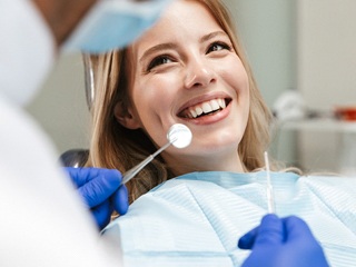 Woman smiling at dentist in treatment chair