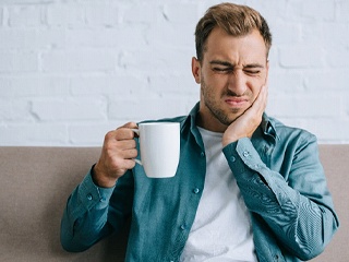 Man experiencing tooth sensitivity