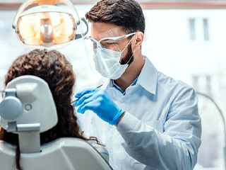 Dentist examining patient's teeth