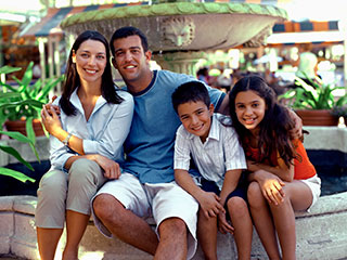 family of four smiling