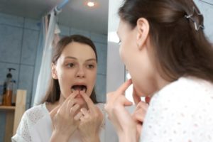 person inserting dental mouthguard