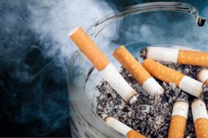 Closeup of smoking cigarettes in an ashtray 